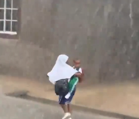 Heartwarming Clip of Young Girl Carrying Brother Through Muddy Road Goes Viral